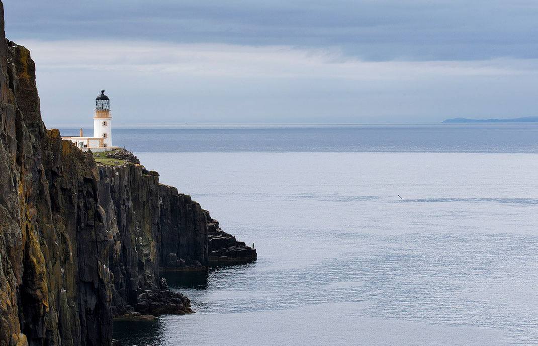 Neist Point Lighthouse on a cliff with ocean and fisherman and seagull, Isle of Skye, Scotland, 1280x823px