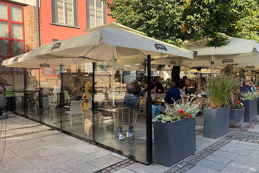 Höhenverstellbarer transparenter Windschutz in der Gastronomie 