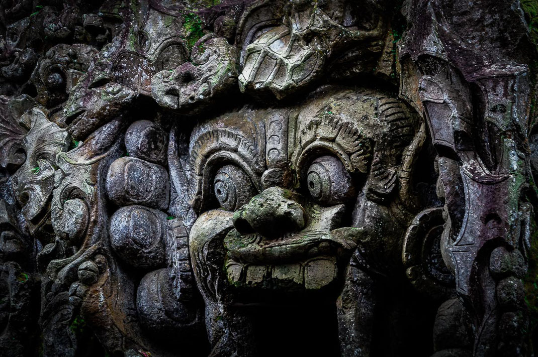 Entrance of Goa Gaja with demons carved in stone.