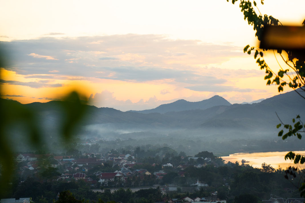 Slowly the sun illuminates the surrounding area and the city of Luang Prabang.