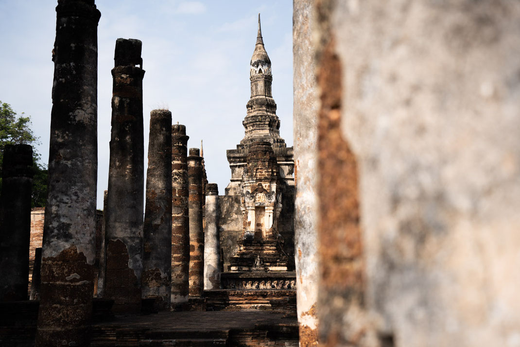 An old temple in Sukhothai, fenced in with pillars.
