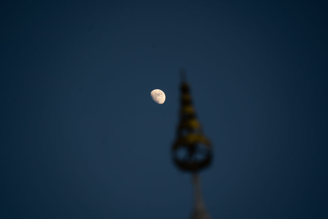 The moon in the early morning over Mount Phou Si.