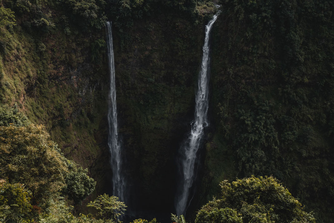 The two high waterfalls plunge down into a basin on the Bolaven Plateau.