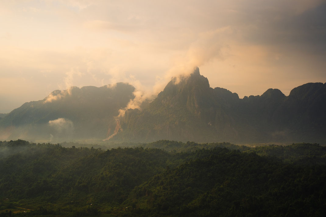 Sunset over the cloud covered mountains of Vang Vieng.