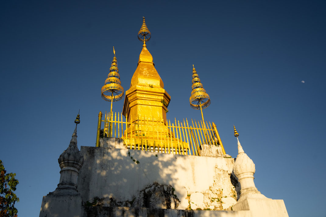 A 20 meter high and golden stupa at Mount Phou Si.