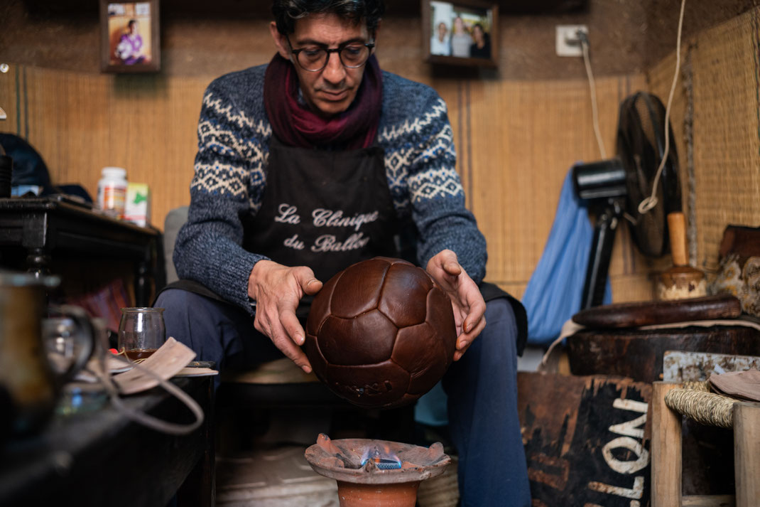Kamal Boukentar handcrafting a football ball at La clinique du ballon - Marrakech Morocco
