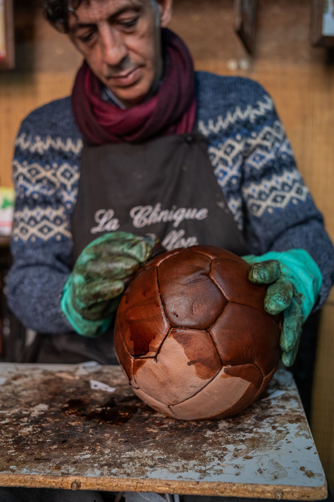 Kamal Boukentar handcrafting a football ball at La clinique du ballon - Marrakech Morocco