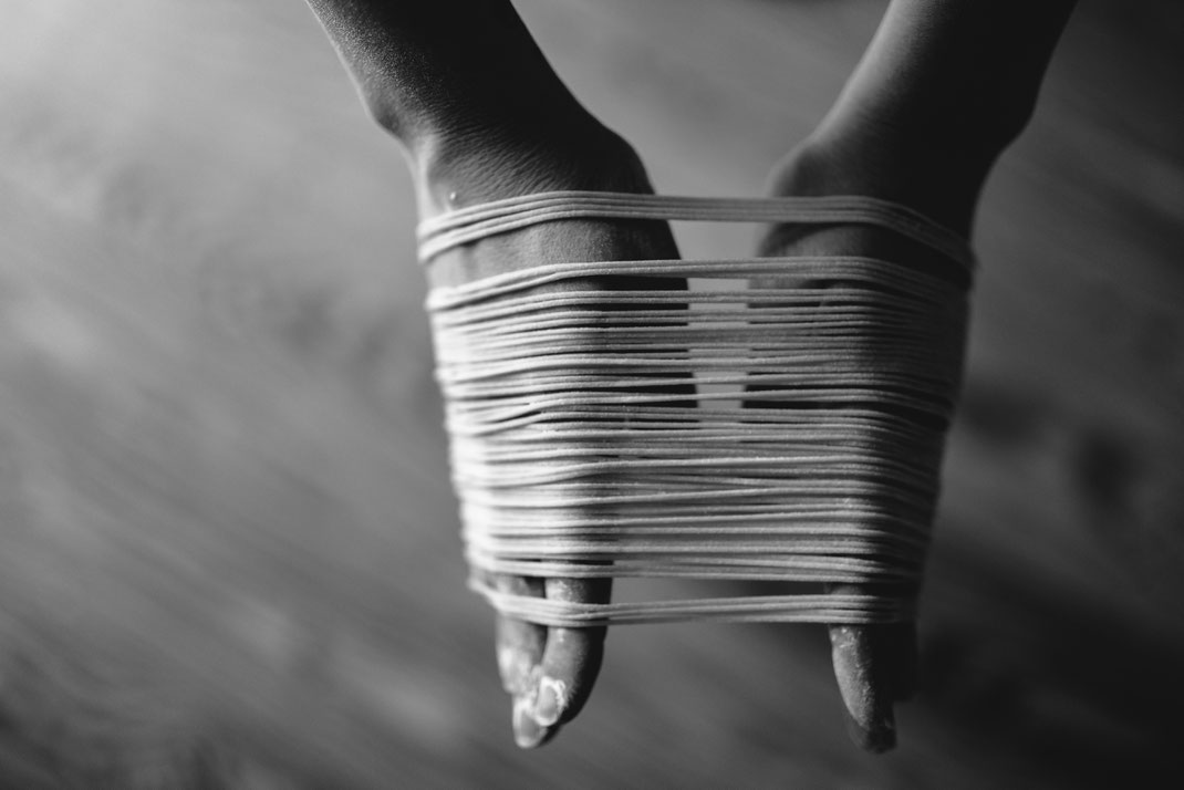 homemade spaghetti on hands