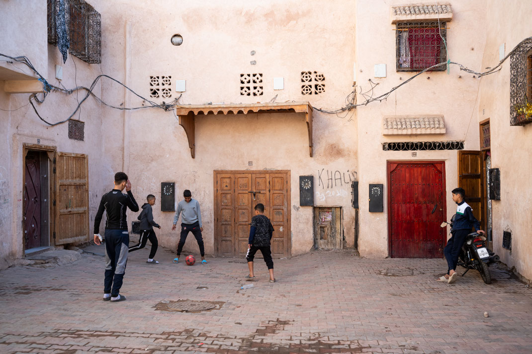 Kids playing football in the streets of the Medina of Marrakech, Morocco
