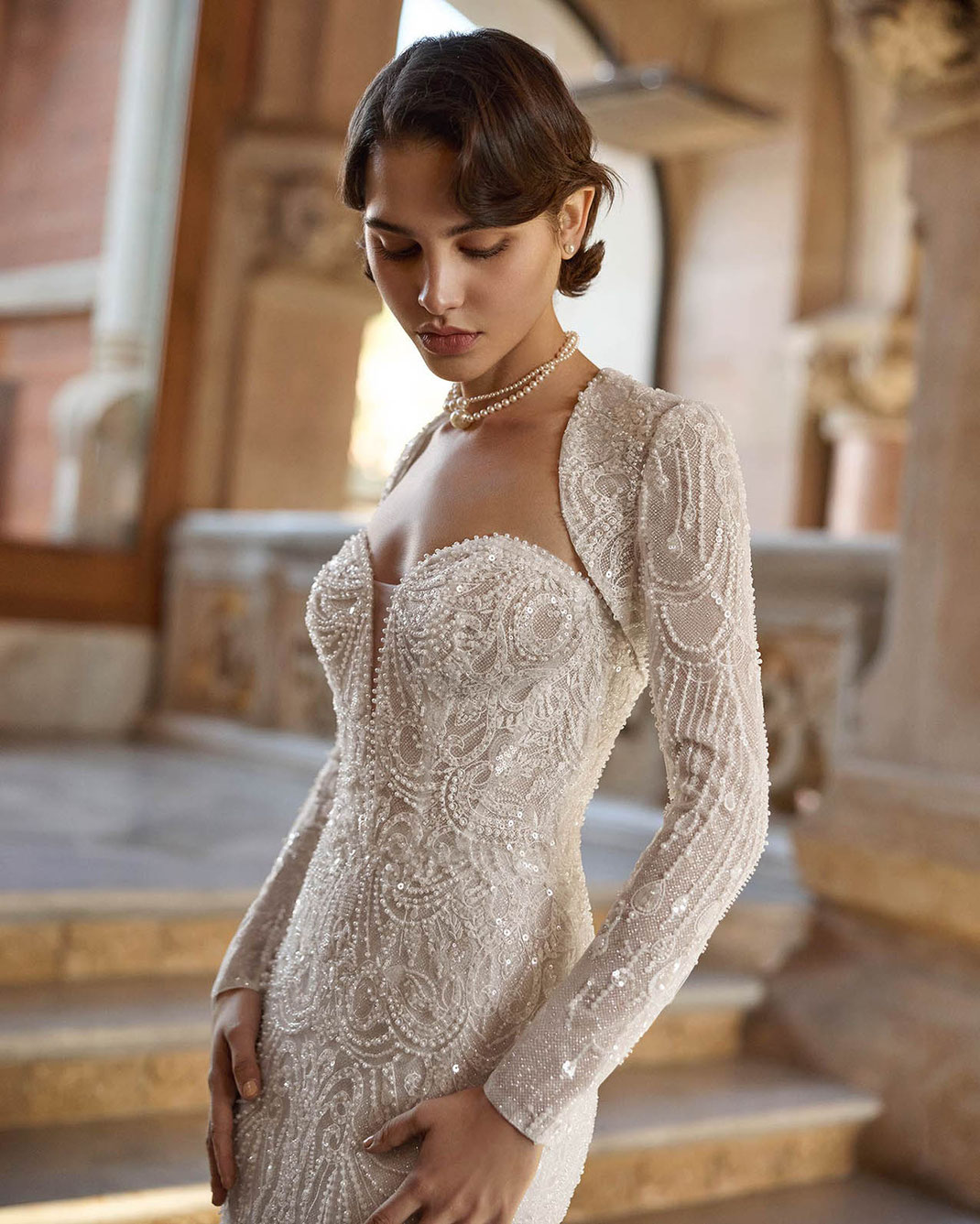 Junge Frau mit einer Kurzhaarfrisur im Stil der 1920er Jahre trägt das Brautkleid Bella von Rosa Clará Gatsby
