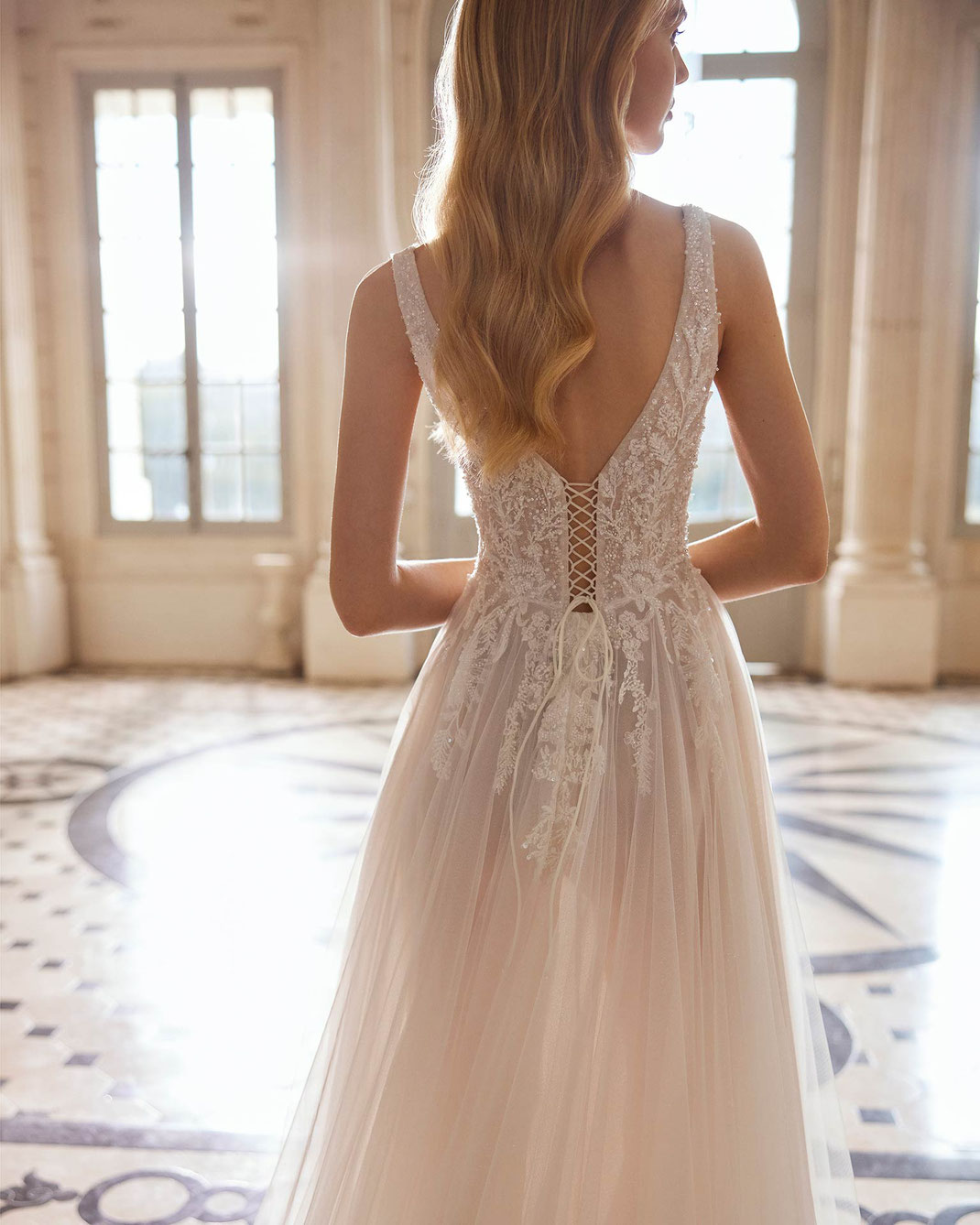 Model mit blonden Haaren trägt das Brautkleid Elenia der neuen Rosa Clará Dreams Kollektion 2025