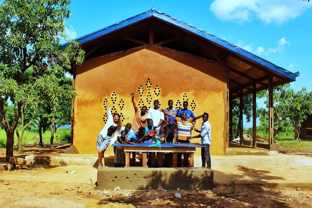 Lida Lioupi and Penny Stergiopoulou with local Ghanaian laborers in front of their project for the NKA Foundation 'A Handmade School for Ghana'