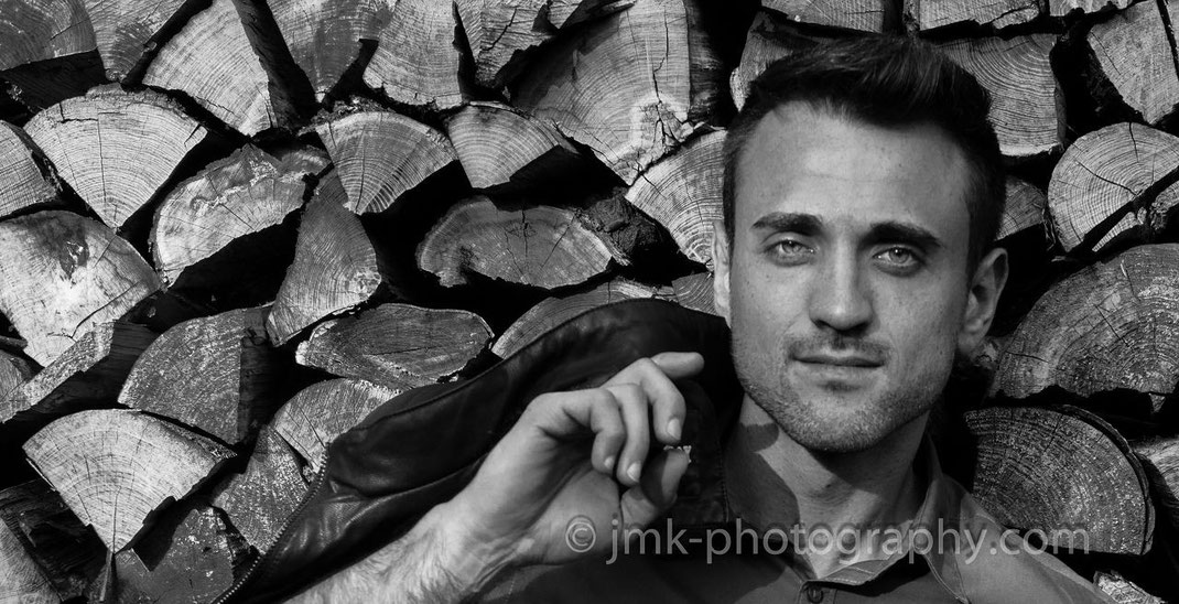 male model on a wood pile, black-white photo