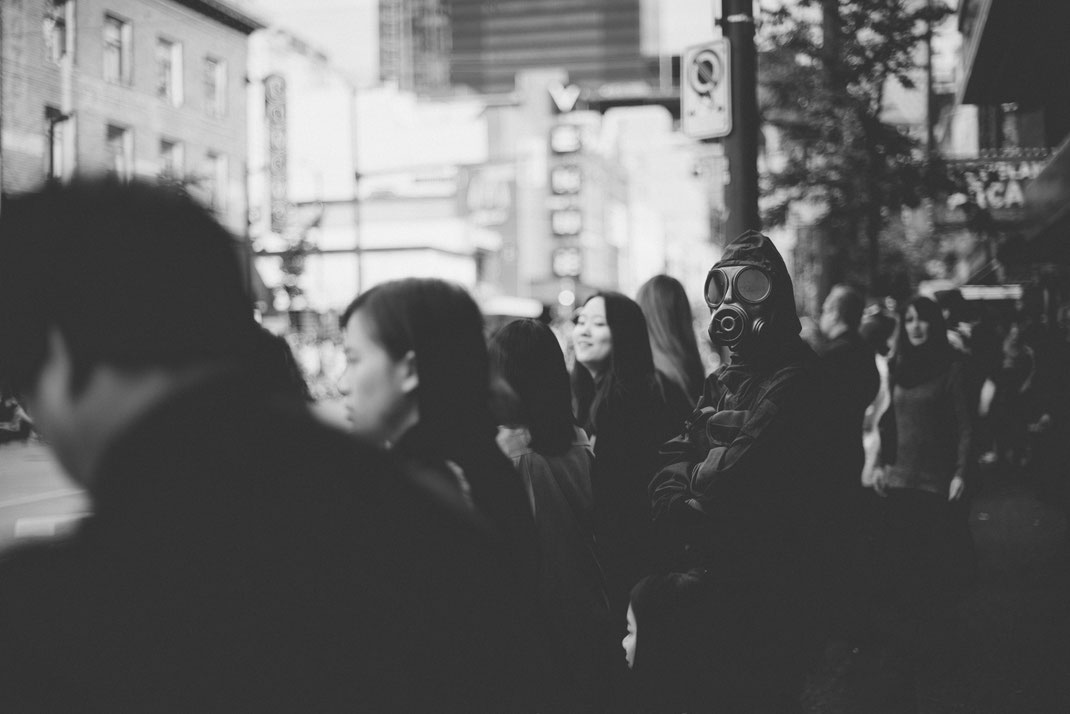 a masked man in special forces uniform watching a Halloween parade