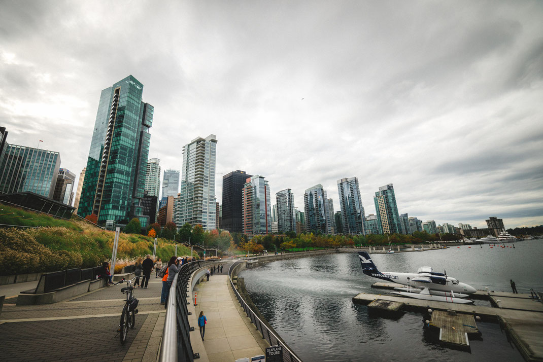 a water plane in front of the city skyline of Vancouver