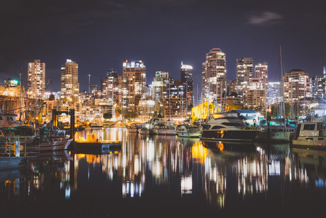 the city skyline of Vancouver at night near False Creek