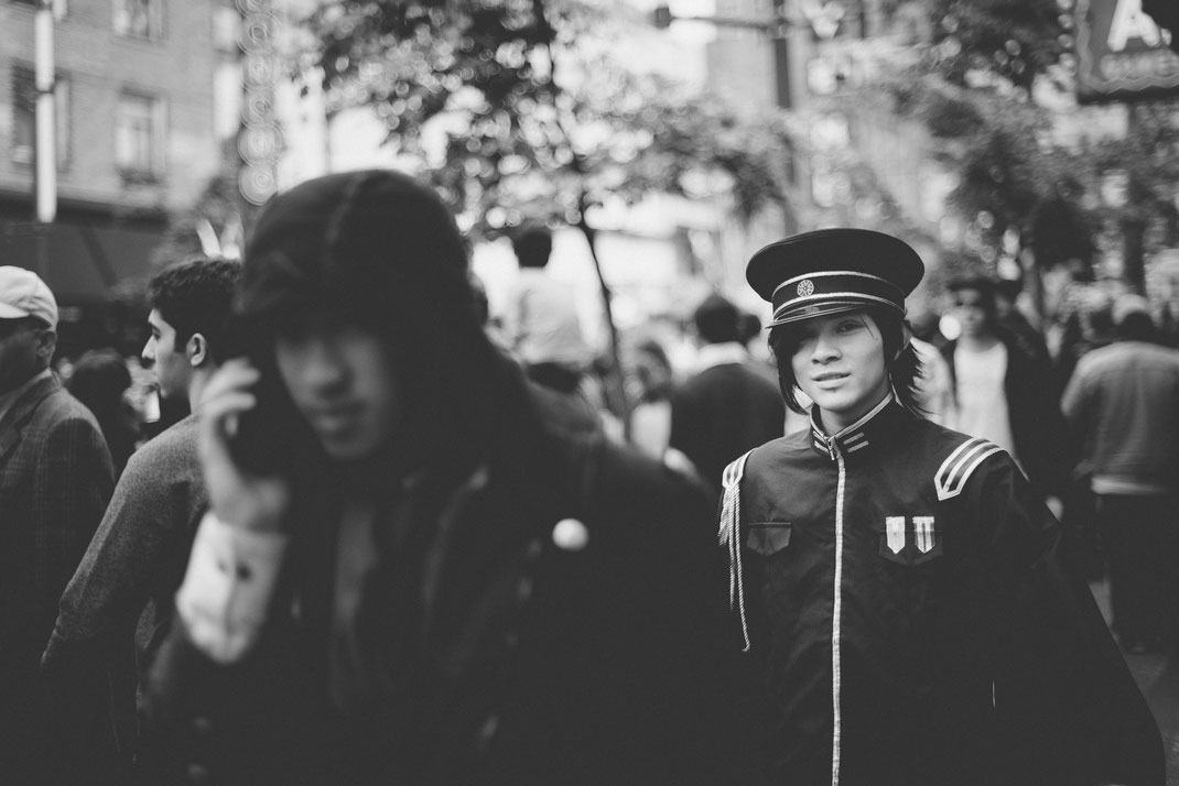 an asian boy in a cosplay costume in the crowd