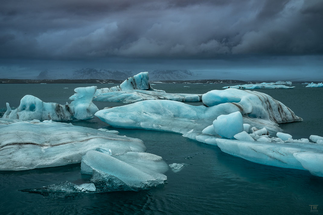 Für einen kurzen Moment verdunkelten sehr dunkle Wolken das Wasser der Gletscherlagune, was einen tollen Kontrast zu den Eisblöcken bot  (B2975)
