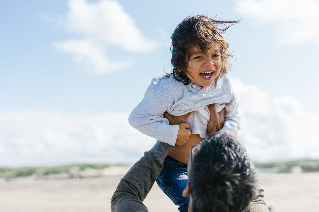 father playing with his son on the beach