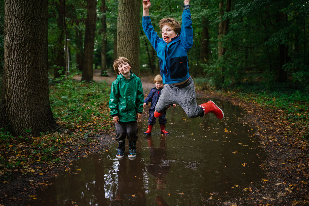 boy jumping in the puddle Oestgeest