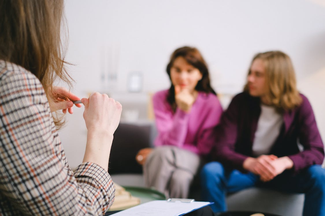 A couple’s counselor listening to a couple talk about their relationship