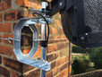 cradle bracket fixing and lashing on chimney for sky satellite dish.