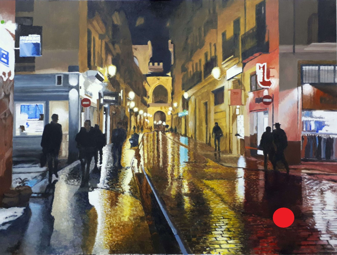 Calle Quart con pavimento mojado, reflejos de luces y ambiente lluvioso en el centro histórico de Valencia.