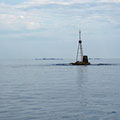 Crossing Sletta, a dangerous sea area with hundreds of rocks and great variations in depts (250-1.5m), during a calm day. Locals fishing around the submerged rocks.