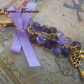 LL007 Llavero dorado de cuentas violetas, con candado, llave y lazo. Largo aprox. 14cm