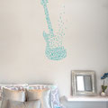 Guitar on a bedroom wall, decal made of musical notes.