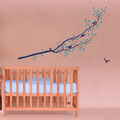 Blue coloured decal with birds and a robin surrounded by flower blossom wall art in a nursery.