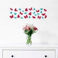 Two different sizes of butterflies vinyl wall art decals on a bedroom wall.