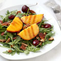 Grilled peach and arugula salad with cherries, bacon, and pecans