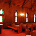 Integration of fire exit door with stained glass into existing wooden church.