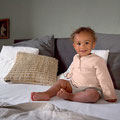 Fröhliches Baby gemütlich sitzend auf einer Couch