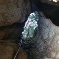 Descending the vertical cave. 