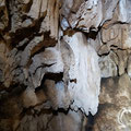 At the bottom of the vertical cave there are some wall decorations. 