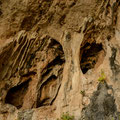 Details of the rocky outskirts of the cave. Many holes that look like caves.