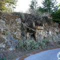 The cave is located next to the asphalt road that leads to the village. 