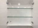 Adjustable glass shelves inside mirrored shaving cabinet