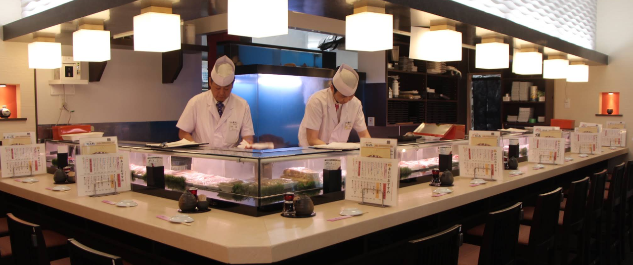 Shinjuku sushi restaurant with casual seating and tourists dining inside