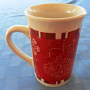 Royal Norfolk mug with white Christmas holiday designs in red background.  