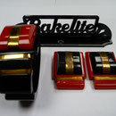 Bakelite clamper bangle and dress clips, red and black.