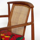 Fåtöljer design Folke Ohlsson för Bra bohag. Stomme i teak, rygg i flätad rotting och sits i tyg 'Tistel' från Jobs handtryck. H.77cm.