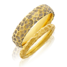Eheringe in Gelbgold mit Jaguar Muster aus der Trauring Kollektion der Goldschmiede OBSESSION Zürich und Wetzikon.