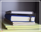 A stack of notebooks and books. Gives a serious and studious vibe. 