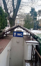 Public toilet with WC sign in front of Riga Opera House
