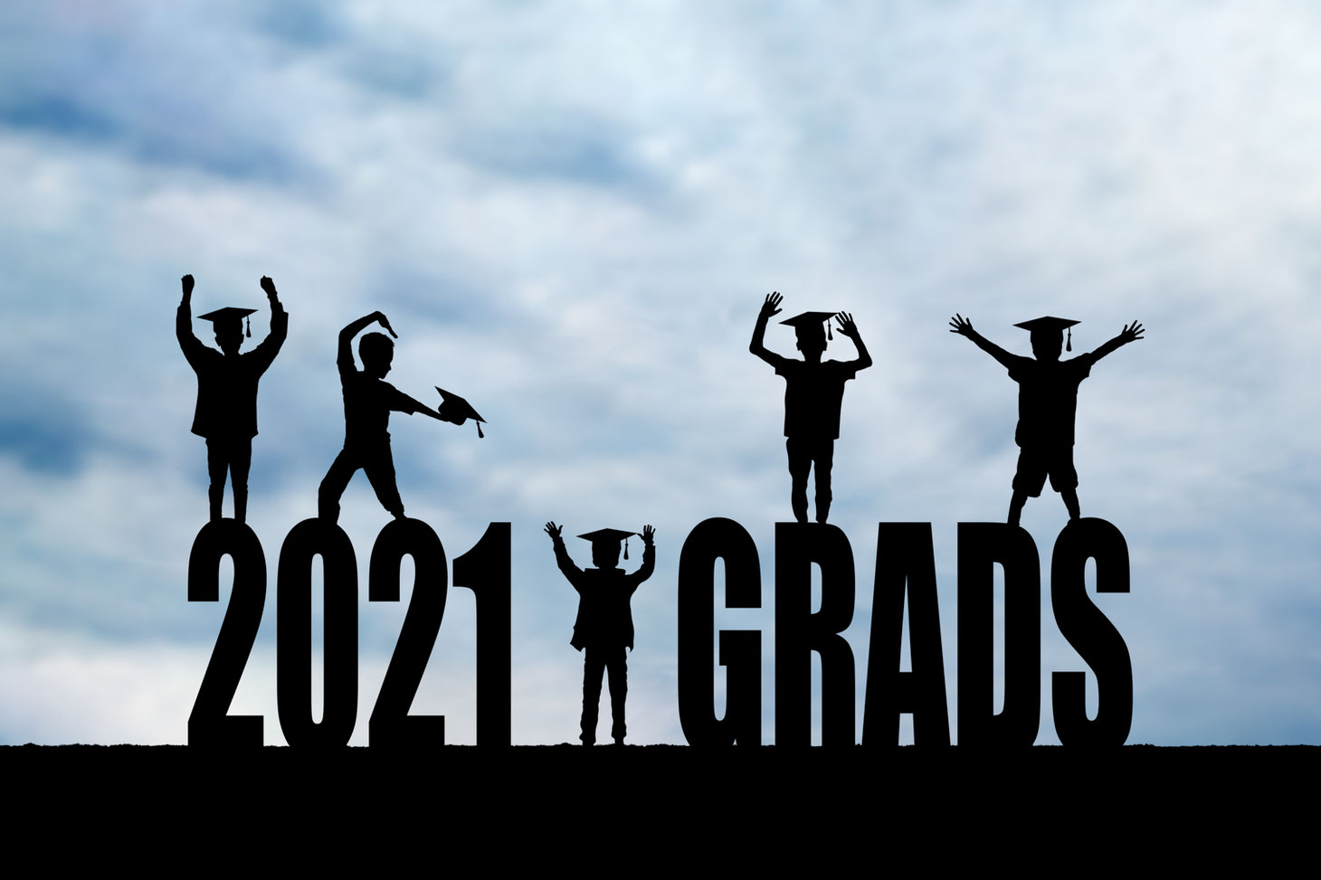 5 boys in silhouette wearing grad caps on block letters reading 2021 grads. The sky is blue