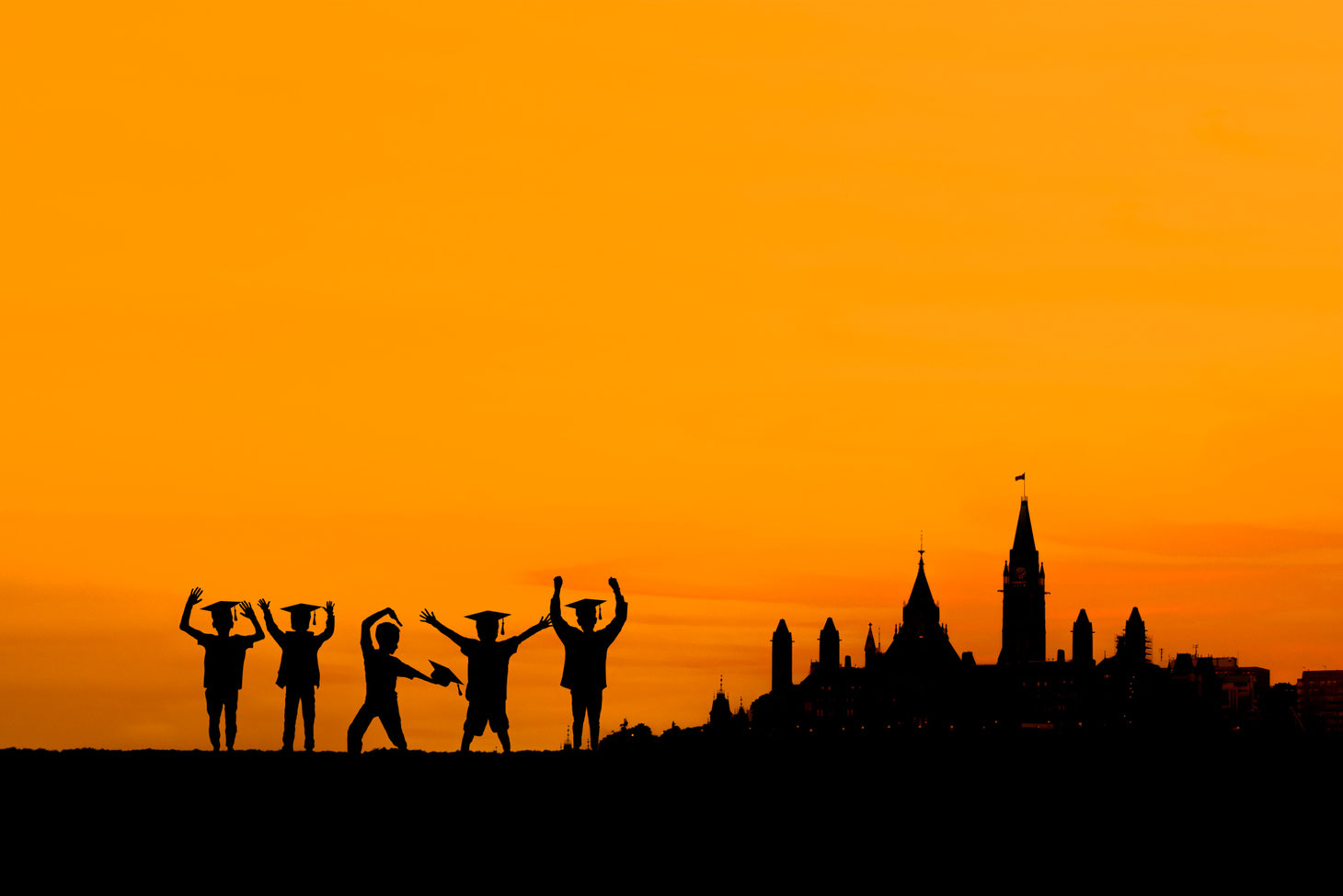 5 boys in silhouette in front of an orange sky next to a silhouette of parliament hill in Ottawa Ontario