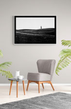 Photo of a sitting room with a grey armchair and a Delphicaphoto black and white fine art print